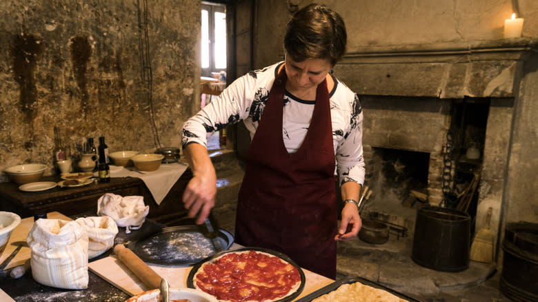 Cook in a Medieval-style kitchen