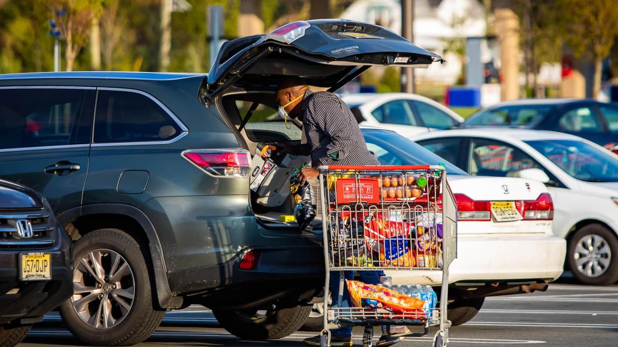 man with full costco cart