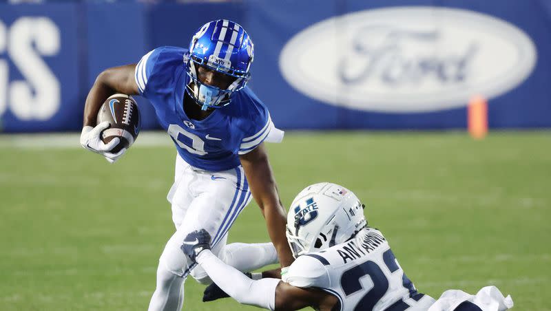 Brigham Young Cougars wide receiver Kody Epps (0) runs on Utah State Aggies cornerback Michael Anyanwu (22) in Provo on Thursday, Sept. 29, 2022.