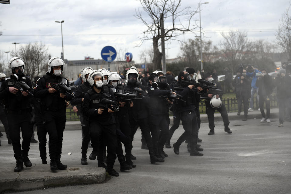 Turkish police officers fire rubber bullets and tear gas at students of the Bogazici University, protesting the appointment of a government loyalist to head their university, during clashes in Istanbul, Tuesday, Feb. 2, 2021. For weeks, students and faculty at Istanbul's prestigious Bogazici University have been protesting President Recep Tayyip Erdogan's appointment of Melih Bulu, a figure who has links to his ruling party, as the university's rector. They have been calling for Bulu's resignation and for the university to be allowed to elect its own president. (AP Photo/Omer Kuscu)