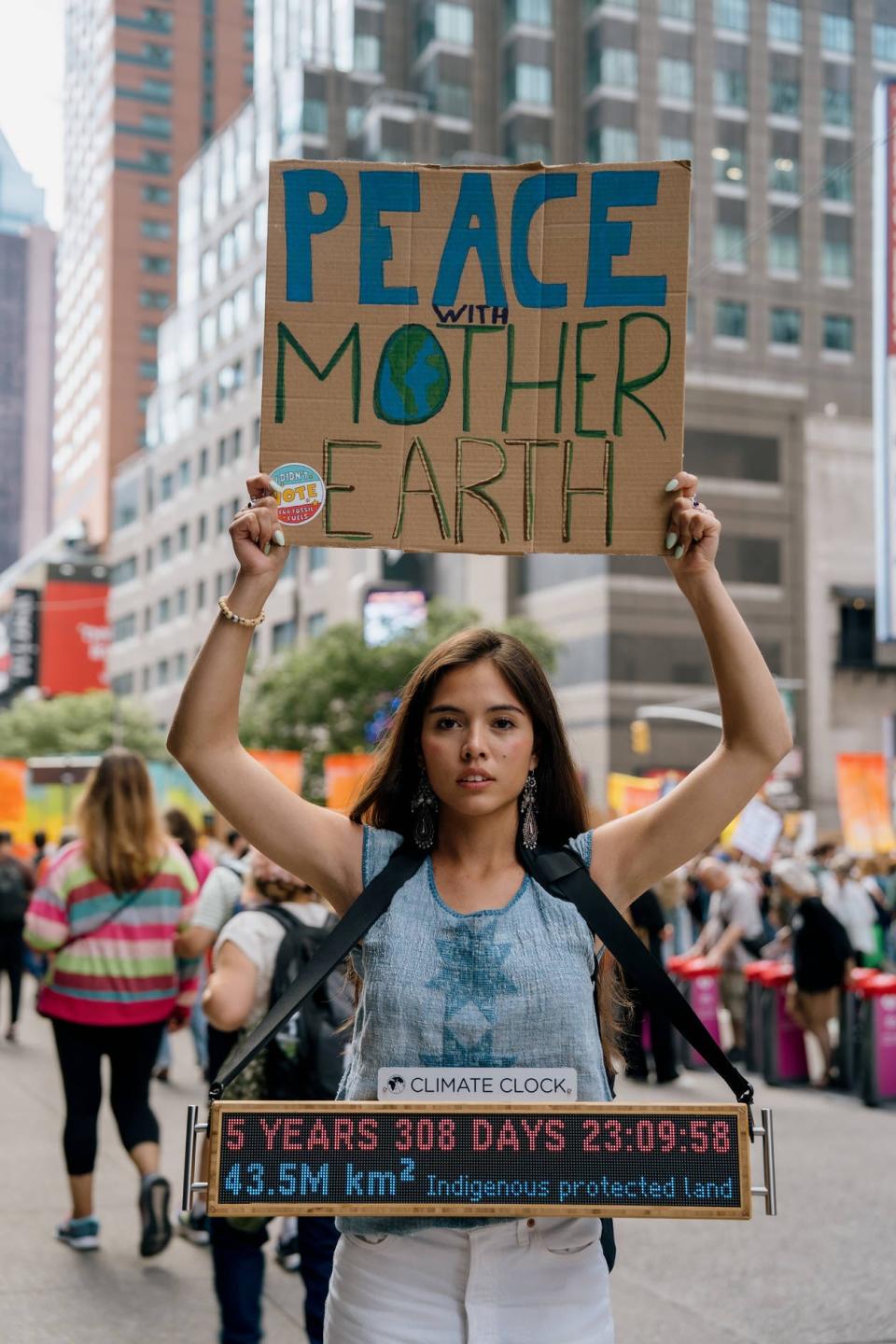 Xiye Bastida, a Climate Clock ambassador, marched in NYC on Sept 17 to end fossil fuels.
