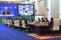 In this photo provided by An Khoun Sam Aun/Ministry of Information of Cambodia, President of the European Council, as the Regional Coordinator for European Group Charles Michel, upper left, is seen on the screen during an online opening session of the Asia-Europe Meeting (ASEM) in Phnom Penh, Cambodia, Thursday, Nov. 25, 2021. Hun Sen on Thursday welcomed leaders of Asian and European nations to the 13th biennial Asia-Europe Meeting, held virtually and postponed from last year due to the coronavirus pandemic. (An Khoun Sam Aun/Ministry of Information of Cambodia via AP)