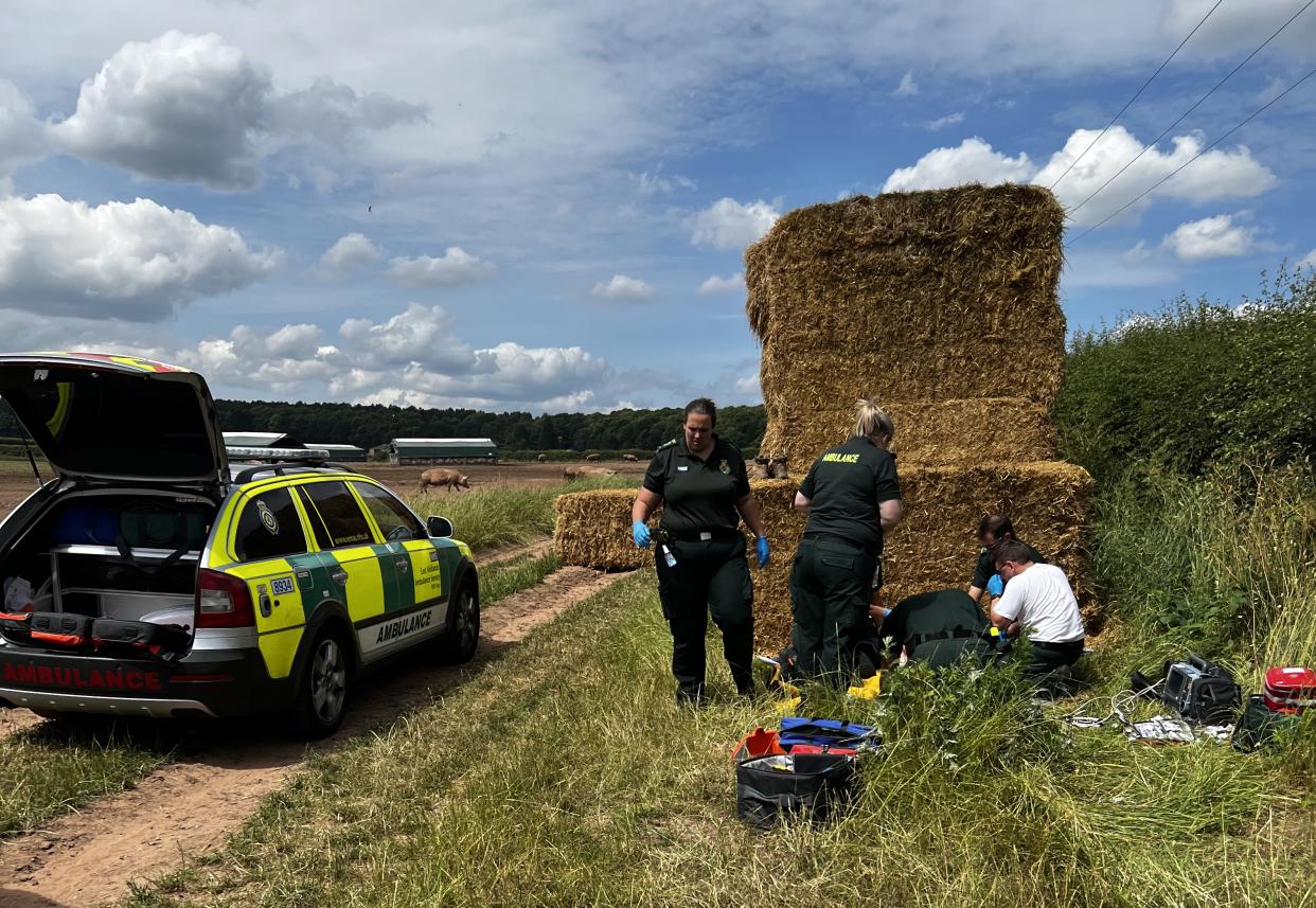 Paramedics help Stephen. See SWNS story SWMRrescue. A farmer who was left trapped under a fallen hay bale was saved after a local who heard him screaming for help used an app to lead emergency services to the right field. Software developer Michael Moss was lapping up the sun outside his North Nottinghamshire home when he heard distant cries for help. Michael, dressed in flip flops and holding a sandwich, immediately sprinted in the general direction of the screams until he stumbled upon an idle tractor in a field. The dad-of-two spotted Stephen, a farmer, trapped under a one tonne haybale in a field with his lower torso completely crushed and immediately ran to his aid. 