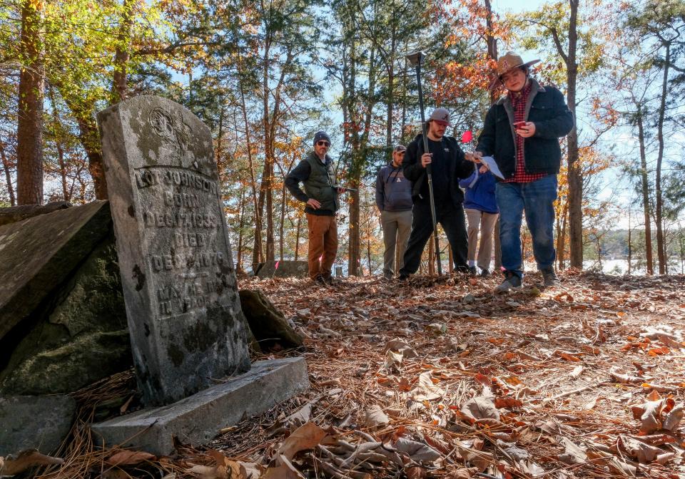 Professor Elliot Blair, left, watches as student from the University of Alabama’s Anthropology Department mark graves in the Prewitt Slave Cemetery in Tuscaloosa County Tuesday, Oct. 31, 2023. From left are Blair, Austin Tanberg, Shawn White, Gregory Galling and Kyle Richard.