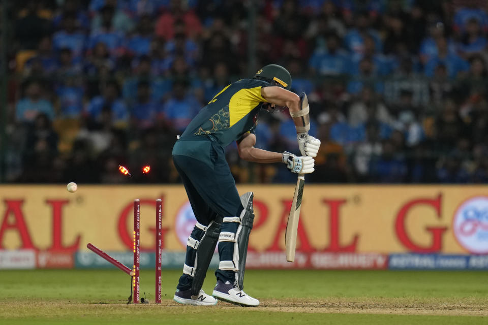 Australia's Ben Dwarshuis is bowled out during the fifth T20 cricket match between India and Australia in Bengaluru, India, Sunday, Dec. 3, 2023. (AP Photo/Aijaz Rahi)