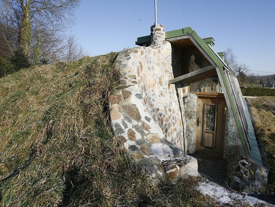 normandy earthship built into the side of a hill