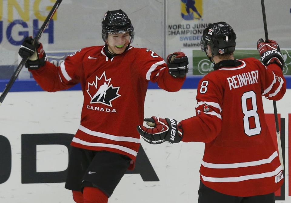 Canada's Lazar celebrates his goal against Switzerland with teammate Reinhart during the third period of their IIHF World Junior Championship ice hockey game in Malmo