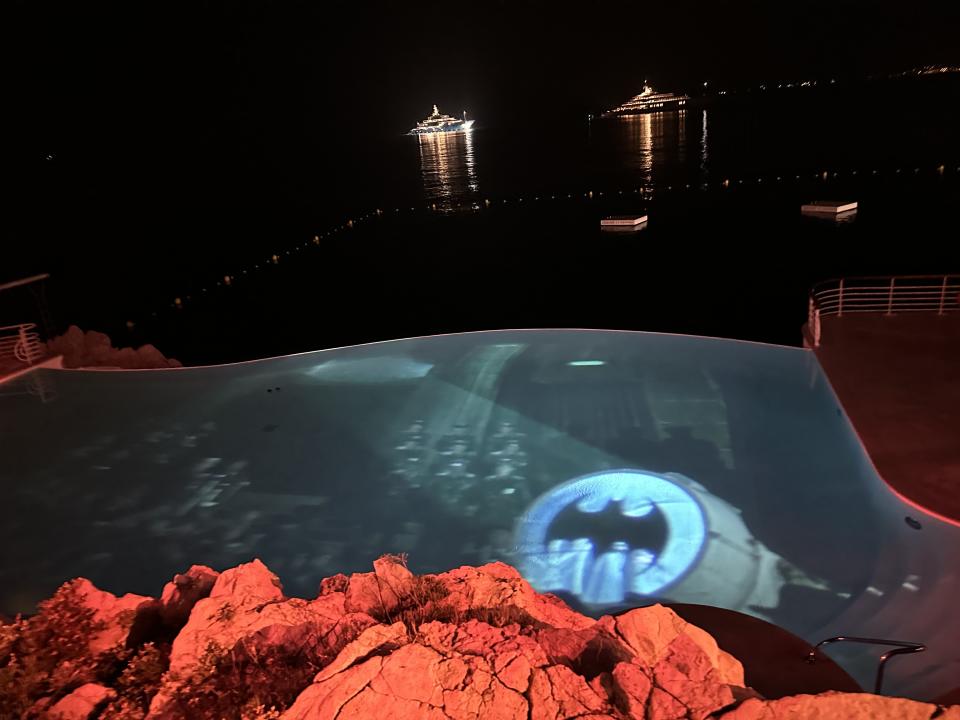 Eden-Roc pool with scenes from Batman movies beamed on the surface. Photo Bamigboye/Deadline.