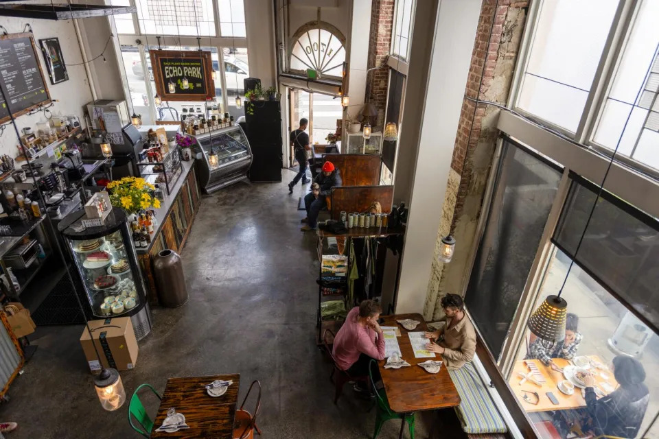 A view from above of a restaurant with lots of windows and glass cases.