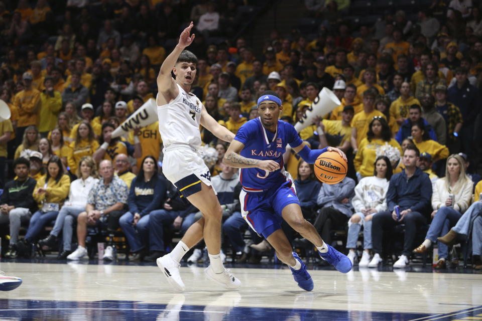 Kansas guard Dajuan Harris Jr. (3) is defended by West Virginia guard Kerr Kriisa (3) during the first half of an NCAA college basketball game on Saturday, Jan. 20, 2024, in Morgantown, W.Va. (AP Photo/Kathleen Batten)