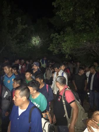 Central Americans are seen in the town of Tantima, Mexico, after Mexican authorities said that they rescued 147 Central Americans abandoned in the wilderness of Veracruz state after alleged human smugglers forced them off the cramped tractor trailer they were traveling in on their way to the United States, in this handout photograph released by Mexican National Institute of Migration on July 30, 2017. National Institute of Migration/Handout via REUTERS.