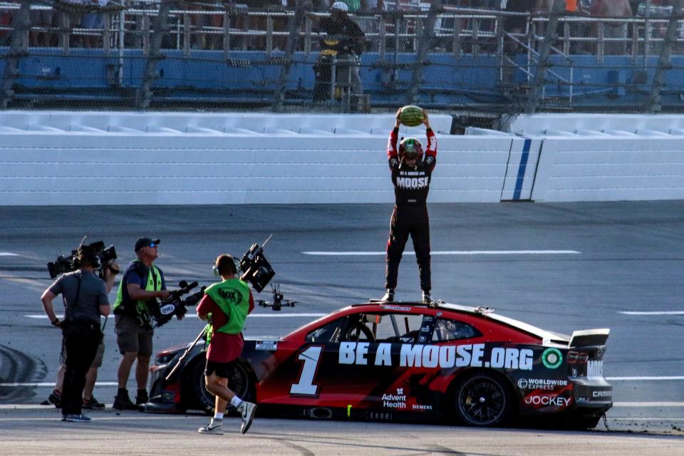 Ross Chastain, top, celebrates by slamming a watermelon to the ground after winning at Talladega Superspeedway on April 24, 2022.