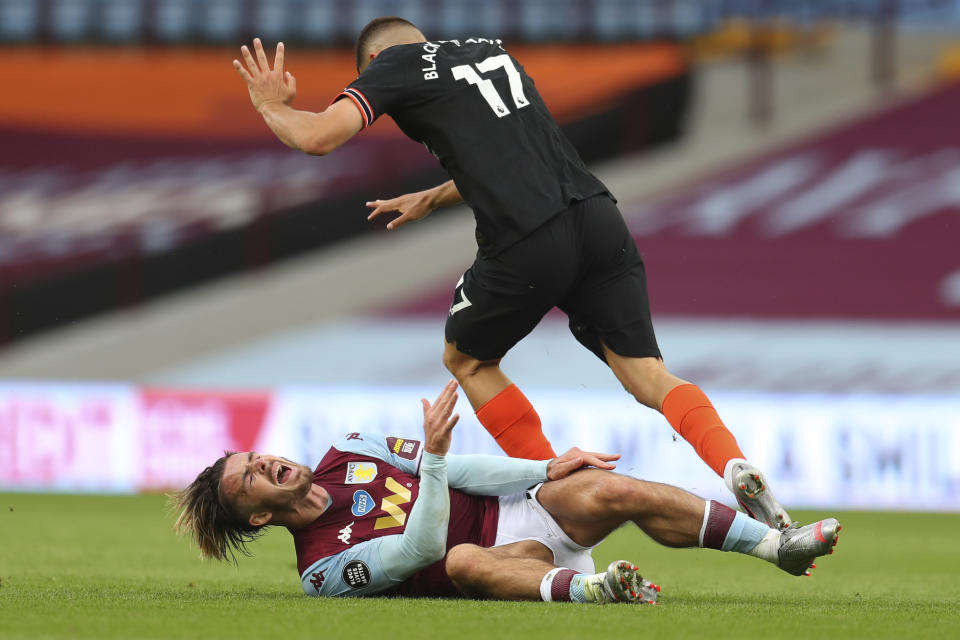 Chelsea's Mateo Kovacic, top, clashes with Aston Villa's Jack Grealish during the English Premier League soccer match between Aston Villa and Chelsea at the Villa Park stadium in Birmingham, England, Sunday, June 21, 2020. (Cath Ivill/Pool via AP)