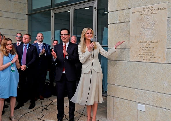 Treasury Secretary Steve Mnuchin claps as US President's daughter Ivanka Trump unveils an inauguration plaque during the opening of the U.S. embassy in Jerusalem on May 14, 2018. (Getty)