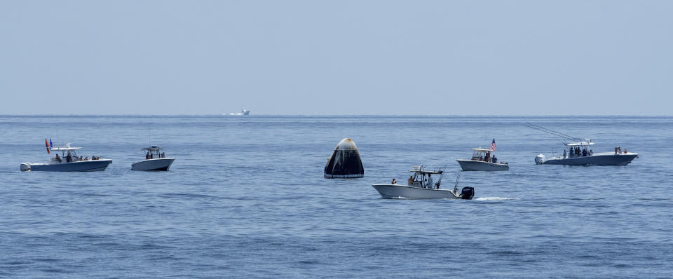 FILE - In this Sunday, Aug. 2, 2020 file photo provided by NASA, support teams and curious recreational boaters arrive near the SpaceX Crew Dragon Endeavour spacecraft in the Gulf of Mexico off the coast of Pensacola, Fla. For the Wednesday, April 28, 2021 planned splashdown, NASA and SpaceX are promising more Coast Guard patrols and fewer pleasure boaters off the Florida panhandle coast for the company's second return of a crew. (Bill Ingalls/NASA via AP, File)