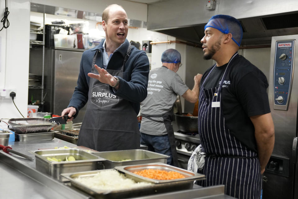 William, the Prince of Wales, helps make bolognese sauce with head chef Mario Confait during a visit to the Surplus to Supper   food charity, in Sunbury-on-Thames, England, April 18, 2024. / Credit: Alastair Grant/Getty