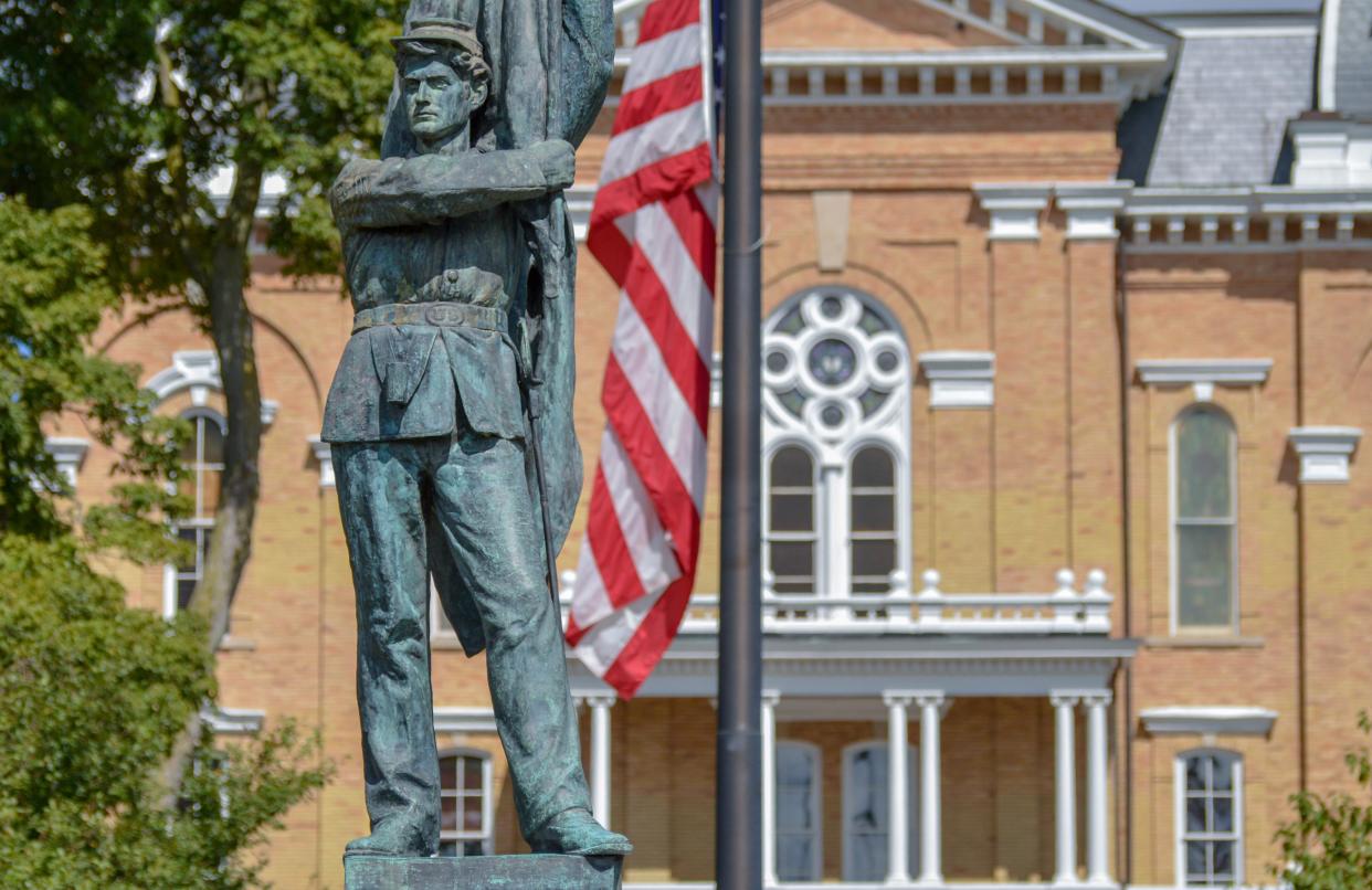 Hillsdale College’s Central Hall pictured behind the backdrop of the campus’s Civil War Memorial.