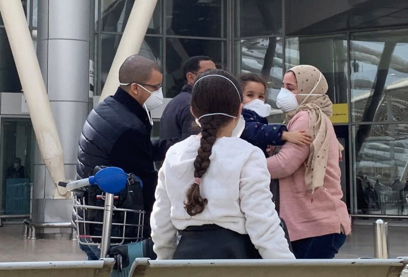 Parents wearing protective face mask hug their children upon their arrival, at Cairo International Airport (CAI) as Egypt ramps up its efforts to slow the spread the coronavirus disease (COVID-19) in Cairo