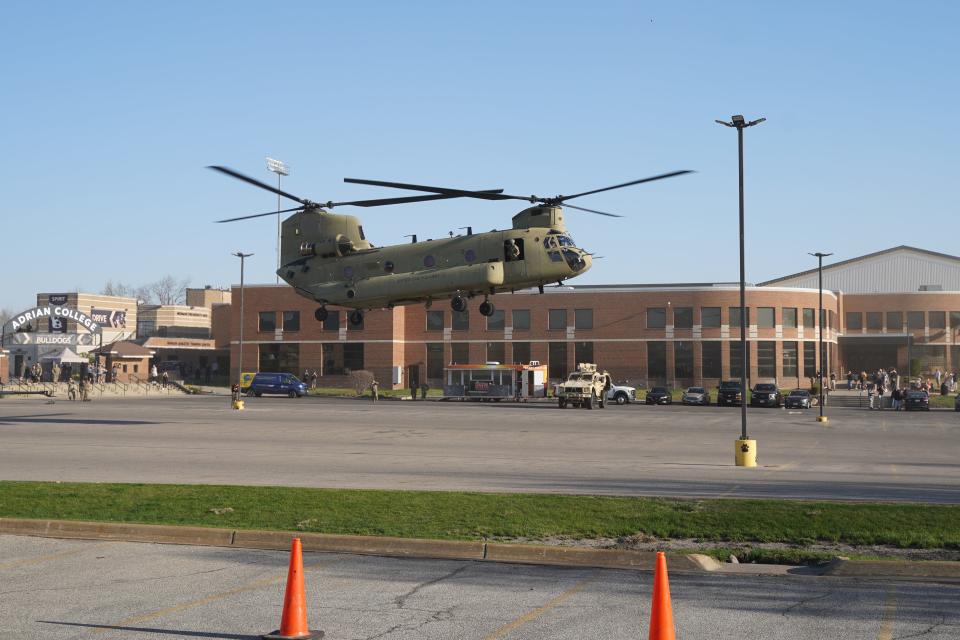 A CH-47 Chinook Helicopter lands Friday, April 14, 2023, at Adrian College's Merillat Sport and Fitness Center during Meet the Army Community Day.