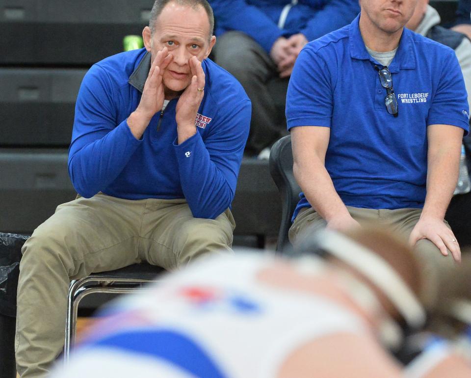 Fort LeBoeuf wrestling coach Shane McChesney exhorts his son Conner McChesney, top, against Sharpsville's Josh Divens during last Saturday's quarterfinal dual of District 10's Class 2A team tournament at Sharon. The Bison finished second and qualified for the PIAA 2A tournament. They beat Frazier 45-25 during Monday's preliminary round and advanced to Thursday's first round at Hershey's Giant Center. District 4 top seed Warrior Run will be their 2 p.m. opponent.