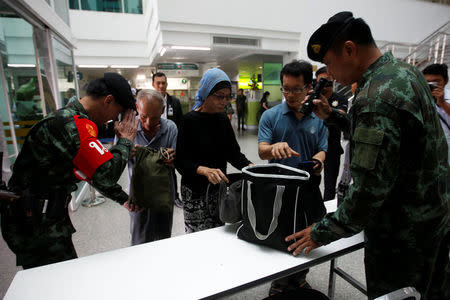 Thai military personnel check the bags of visitors at an entrance of the Phramongkutklao Hospital in Bangkok, Thailand, May 23, 2017. REUTERS/Chaiwat Subprasom