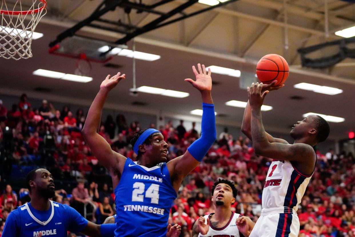 Jan 26, 2023; Boca Raton, Florida, USA; Florida Atlantic Owls guard Johnell Davis (1) shoots over Middle Tennessee Blue Raiders guard Camryn Weston (24) during the second half at Eleanor R. Baldwin Arena. Mandatory Credit: Rich Storry-USA TODAY Sports