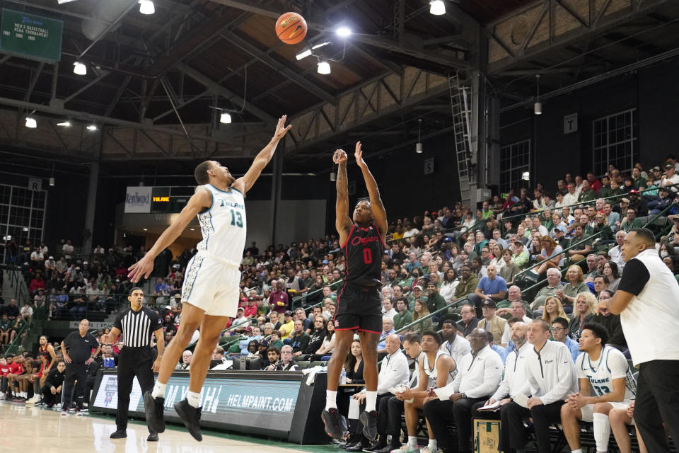 Houston guard Marcus Sasser (0) shoots against Tulane forward Tre' Williams (13) during the first half of an NCAA college basketball game in New Orleans, Tuesday, Jan. 17, 2023. Houston won 80-60. (AP Photo/Gerald Herbert)