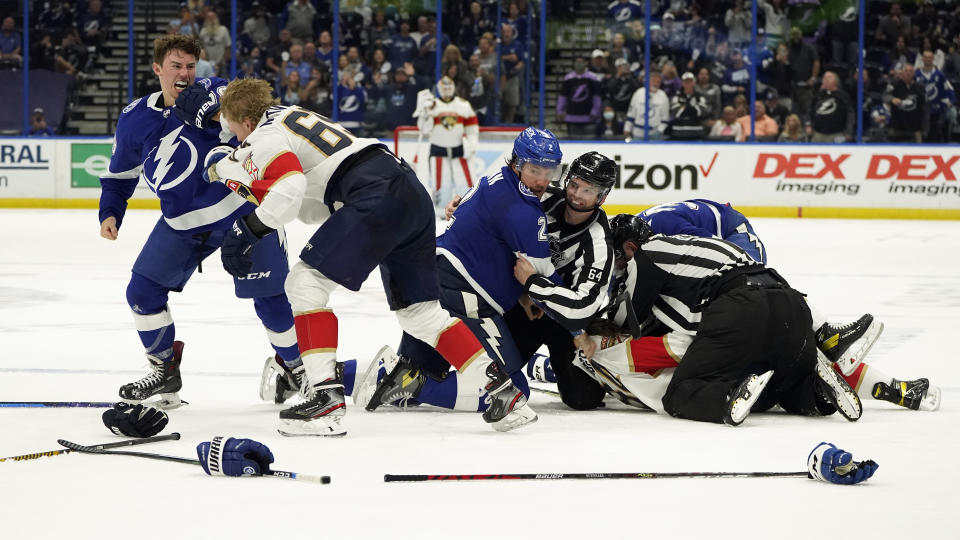 Tampa Bay Lightning left wing Ross Colton (79) and Florida Panthers defenseman Markus Nutivaara (65) fight during the third period in Game 4 of an NHL hockey Stanley Cup first-round playoff series Saturday, May 22, 2021, in Tampa, Fla. (AP Photo/Chris O'Meara)