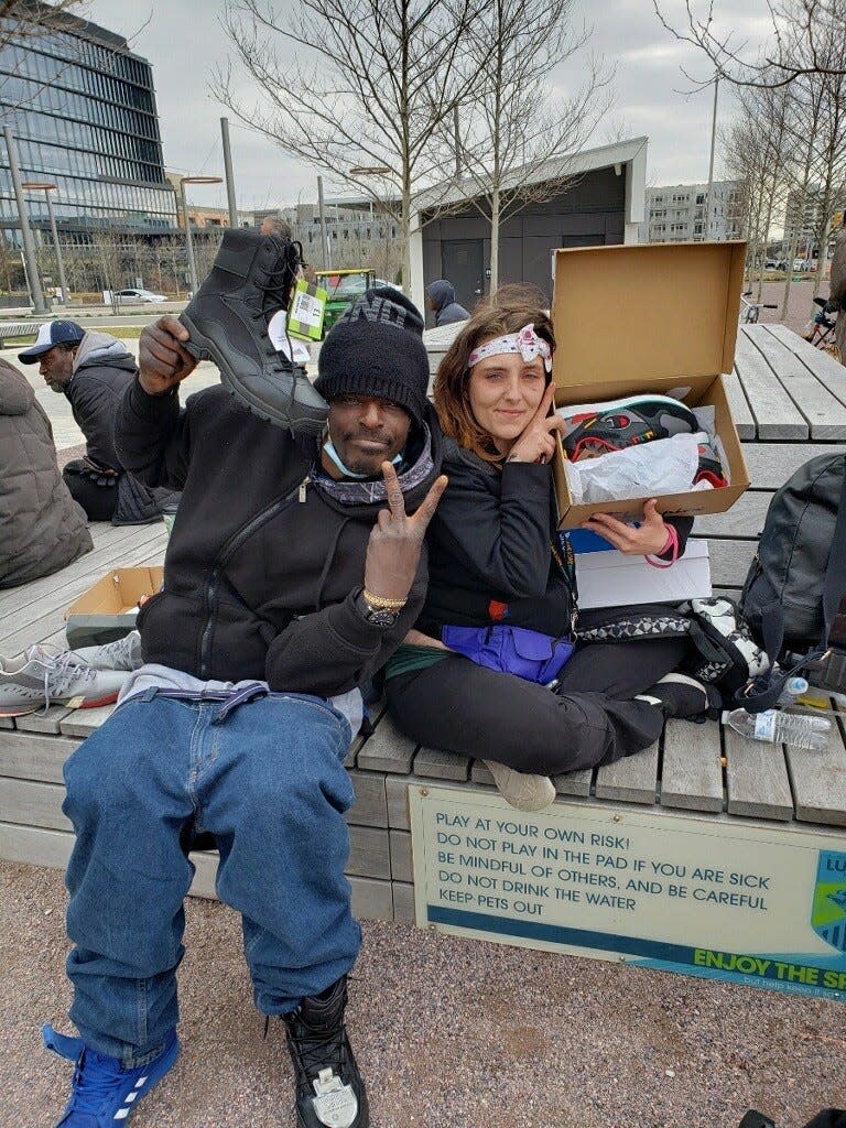 Taylor George, right, poses with new shoes she insisted on providing for a man she saw living on the streets in Indianapolis. His shoes had no soles under them, said Elder Coleman of Refuge Place Indy.