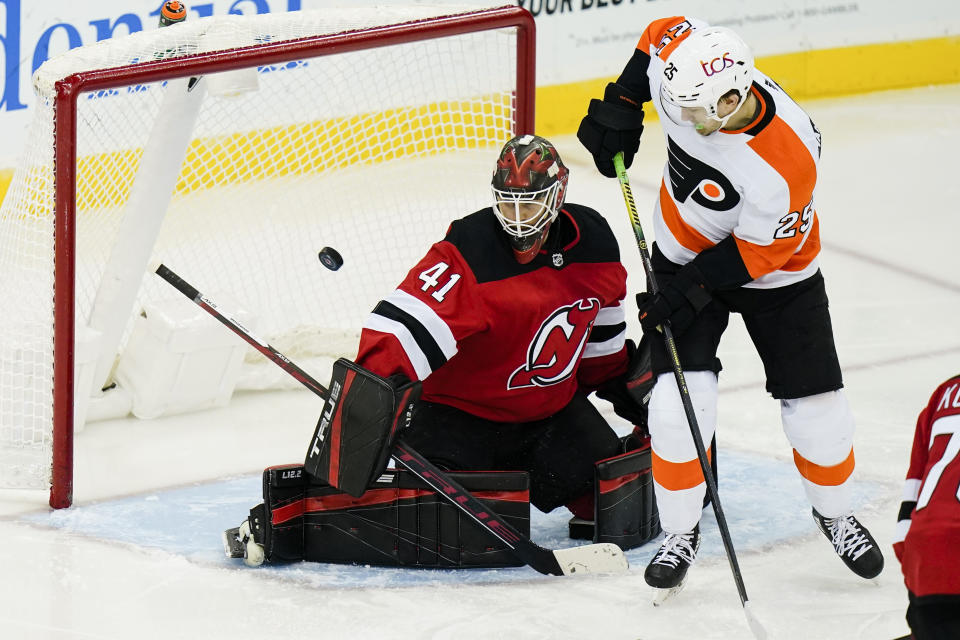 Philadelphia Flyers' James van Riemsdyk (25) scores a goal as New Jersey Devils goaltender Scott Wedgewood (41) defends during the second period of an NHL hockey game Tuesday, Jan. 26, 2021, in Newark, N.J. (AP Photo/Frank Franklin II)