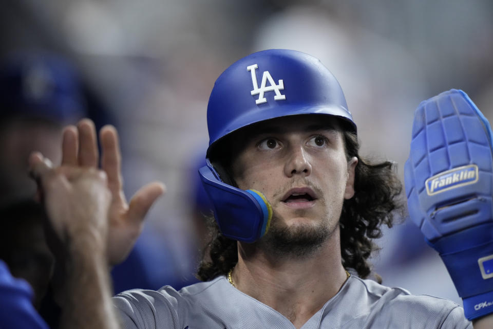 Los Angeles Dodgers' James Outman celebrates with teammates after he scored on a single by Freddie Freeman during the third inning of a baseball game against the Miami Marlins, Tuesday, Sept. 5, 2023, in Miami. (AP Photo/Wilfredo Lee)