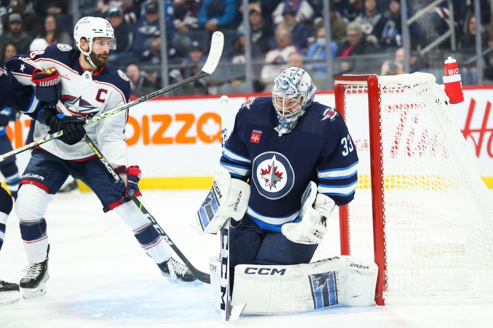 Dec 2, 2022; Winnipeg, Manitoba, CAN; Columbus Blue Jackets captain Boone Jenner watched teammate Patrik Laine's shotbeat Winnipeg Jets goalie David Rittich (33) for a 1-0 lead in the first period Friday night at Canada Life Centre. Mandatory Credit: Terrence Lee-USA TODAY Sports
(Photo: Terrence Lee, Terrence Lee-USA TODAY Sports)