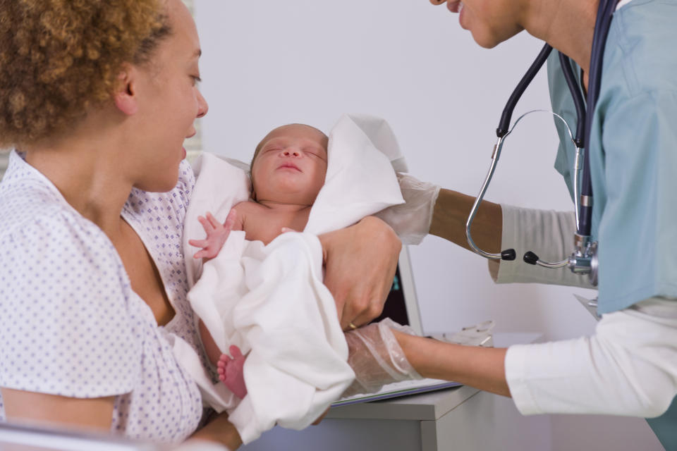 Woman being given baby after birth. (Getty images)