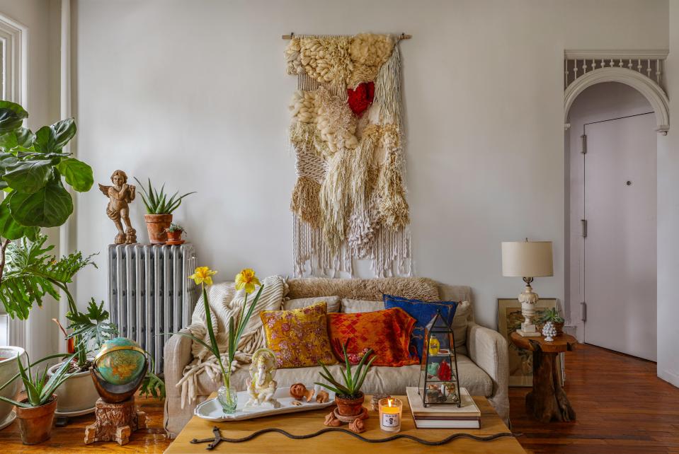 Mikey’s apartment is totally his own, but the wall hanging behind his couch, made by their mutual friend Erik Speer, is a reminder of his husband. “I got him that for Christmas this past year,” says Darroch. “It's made of all different kinds of yarns and textures and layers. I wanted to give him a big tapestry piece, and I just love it. I think it's so cool. And I think it looks so beautiful in front of that couch.” Of course, it’s Darroch’s favorite detail in the space.