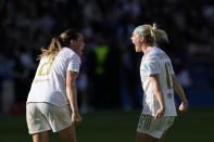 Lyon's Vanessa Gilles, left, and Ellie Carpenter celebrate at the end of the women's Champions League semifinal, second leg, soccer match between Paris Saint-Germain and Olympique Lyonnais at Parc des Princes, in Paris, Sunday, April 28, 2024. Lyon won 2-1 to advance to the final. (AP Photo/Thibault Camus)