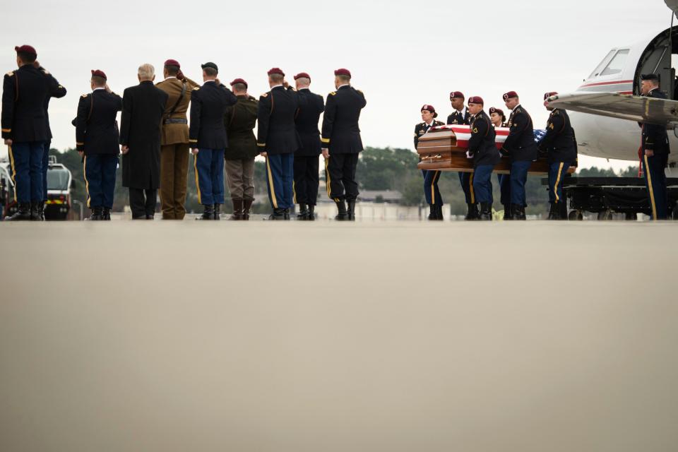 The remains of Staff Sgt. Ian Paul McLaughlin are carried from a plane to an awaiting hearse on Fort Bragg, N.C., on Saturday, Jan. 18, 2020.  McLaughlin was killed Jan. 11 in Afghanistan.