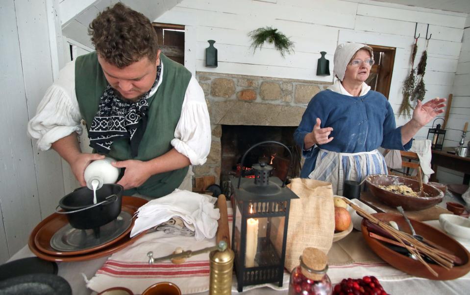 William Young demonstrates how to make cheese as Susie Worcester explains the making of Christmas pudding during the Spirit of Christmas Past event held Saturday, Dec. 3, 2022, at the Kings Mountain Historical Museum.