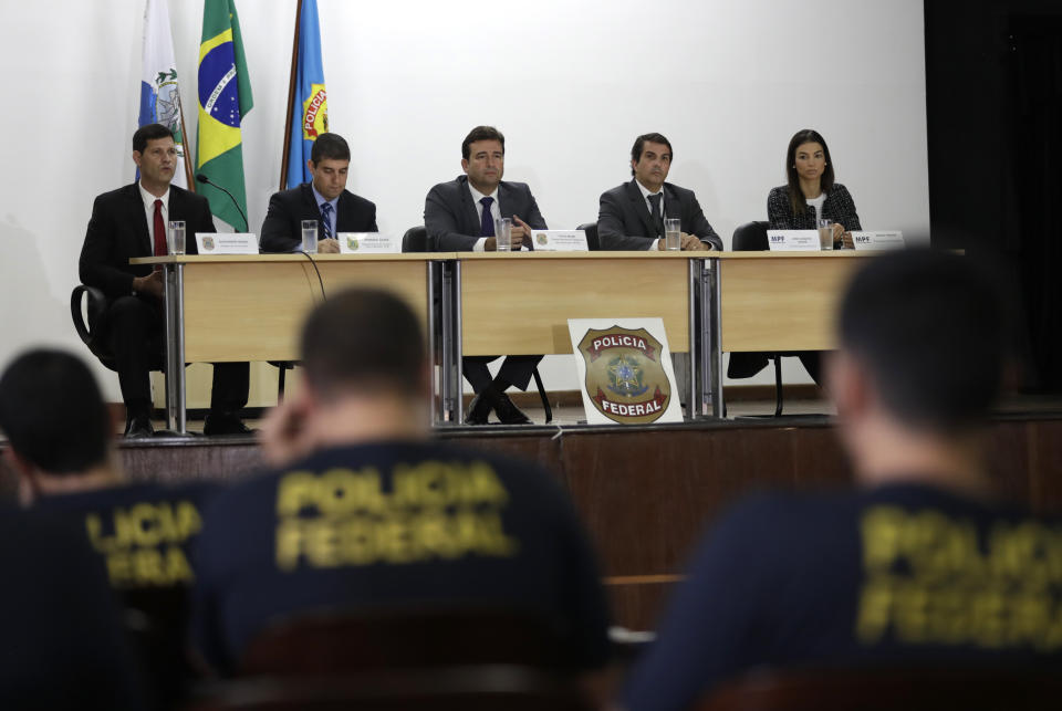 Authorities hold a press conference regarding the investigation into kickbacks and money laundering that they say involve Paraguay's ex-President Horacio Cartes, at Federal Police headquarters, in Rio de Janeiro, Brazil, Tuesday, Nov. 19, 2019. Brazilian police are seeking the arrest of the former president as part of the investigation. (AP Photo/Silvia Izquierdo)