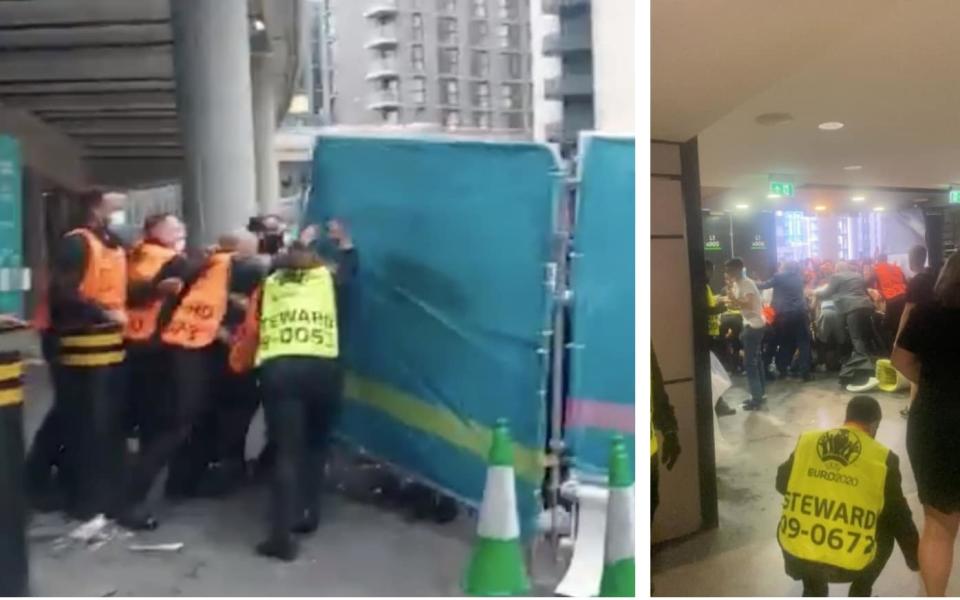 Stewards try to stop fans storming their way into Wembley.