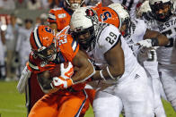 North Carolina State's Alim McNeill (29) ties up Syracuse's Abdul Adams (23) during the first half of an NCAA college football game in Raleigh, N.C., Thursday, Oct. 10, 2019. (AP Photo/Karl B DeBlaker)