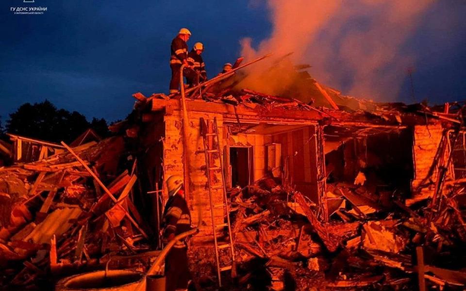 Firefighters work at a site of residential area heavily damaged during a Russian missile strike in the town of Zviahel - STATE EMERGENCY SERVICE OF UKRAINE/via REUTERS