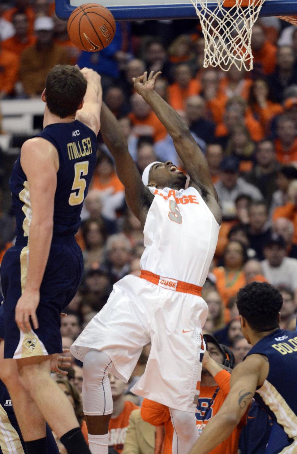 Syracuse's C. J. Fair has his shot blocked by Georgia Tech's Daniel Miller during the first half of an NCAA college basketball game in Syracuse, N.Y., Tuesday, March 4, 2014. (AP Photo/Kevin Rivoli)