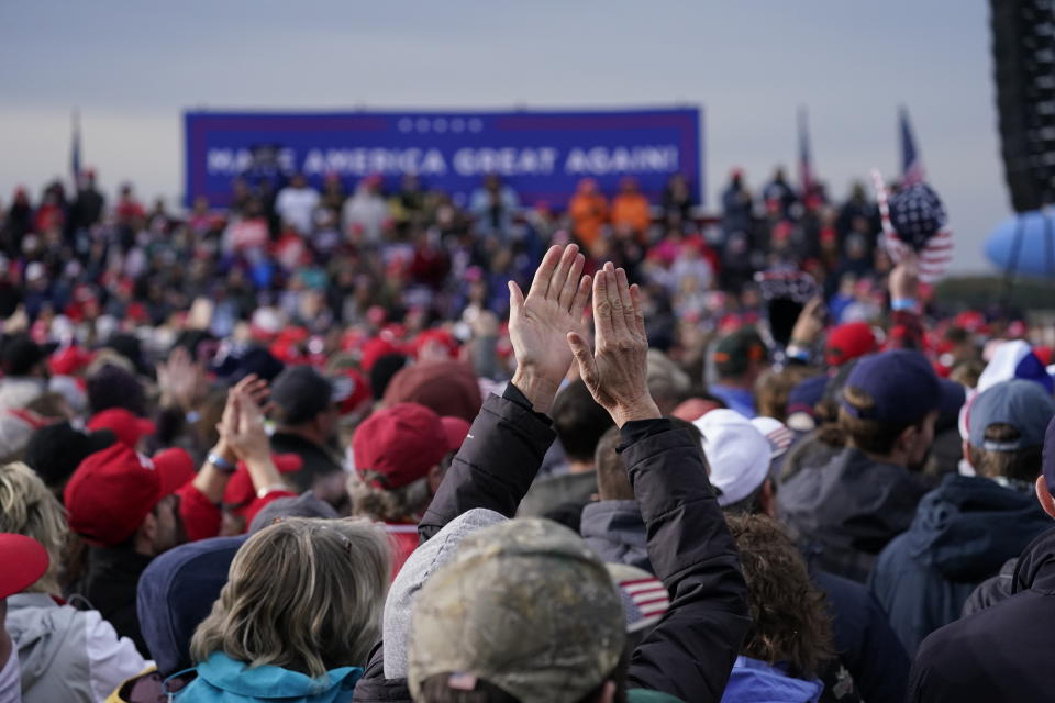 Supporters of President Donald Trump cheer as he speaks during a campaign rally at Muskegon County Airport, Saturday, Oct. 17, 2020, in Norton Shores, Mich. (AP Photo/Alex Brandon)