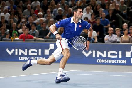 World number one Novak Djokovic of Serbia runs to return to Britain's Andy Murray in their men's singles final tennis match at the Paris Masters tennis tournament November 8, 2015. REUTERS/Charles Platiau