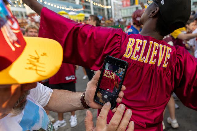 <p>Getty Images</p> Washington Commanders fans celebrate after NFL team owners unanimously approved Josh Harris's purchase of the team from Daniel Snyder, at The Bullpen's "Burgundy and Sold" party on Thursday, July 20, 2023.