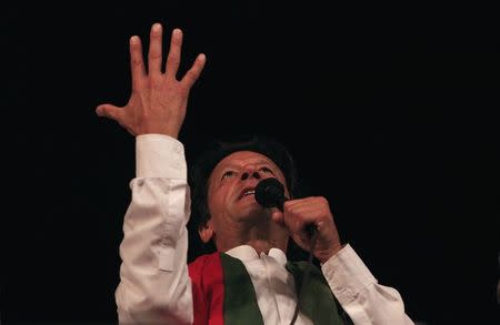 Imran Khan, the Chairman of the Pakistan Tehreek-e-Insaf (PTI) political party, addresses supporters in front of the Parliament house building during what has been dubbed a "freedom march" in Islamabad August 28, 2014. REUTERS/Faisal Mahmood