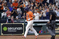 Houston Astros' Martin Maldonado (15) reacts as he crosses home plate in front of umpire Alan Porter, right, after his two-run home run during the fifth inning of a baseball game against the Texas Rangers, Friday, May 14, 2021, in Houston. (AP Photo/Michael Wyke)