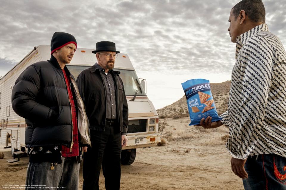 Three men talk in a scene from the Frito-Lay PopCorners 2023 Super Bowl spot.