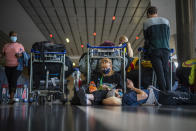 Students from Norway who were on a field trip to South Africa wait to be tested for COVID-19 before boarding a flight to Amsterdam at Johannesburg's OR Tambo's airport Monday Nov. 29, 2021. The World Health Organisation urged countries around the world not to impose flight bans on southern African nations due to concern over the new omicron variant. (AP Photo/Jerome Delay)