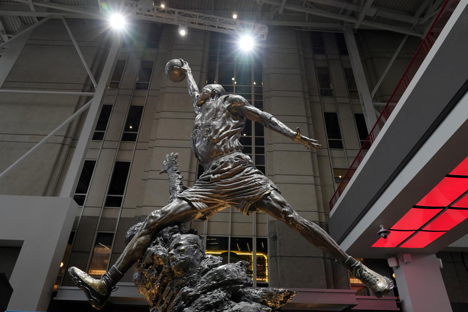 FILE - The Michael Jordan statue on display in the United Center atrium during the Bulls NBA basketball media day Monday, Sept. 26, 2022, in Chicago. The 19-foot, 4,000-pound statue of Kobe Bryant in downtown Los Angeles is just the latest example of a sports team honoring a player with this kind of larger-than-life presence.(AP Photo/Charles Rex Arbogast, File)